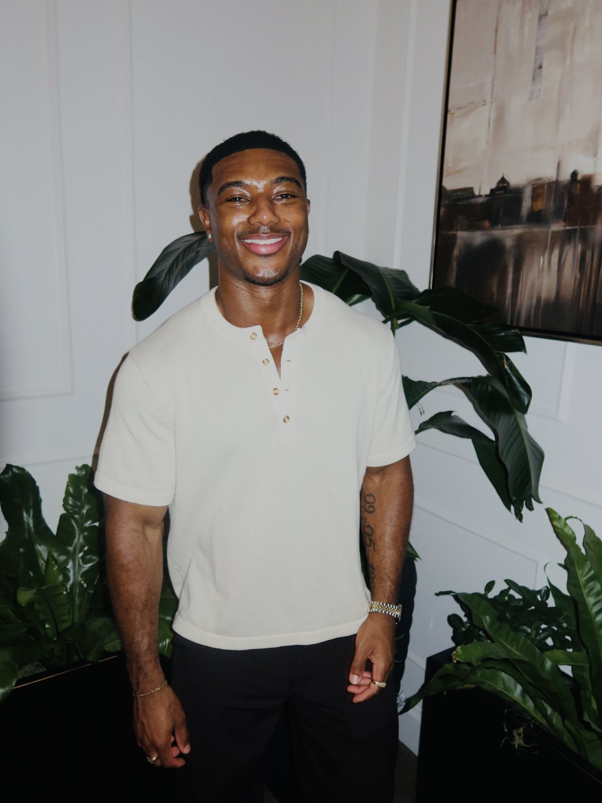 Edward Banks smiling in a cream henley